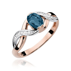 Kihlasõrmus. Two-tone ring with a blue oval gemstone set in rose gold, featuring pavé diamonds along the twisted white-gold shoulders.
