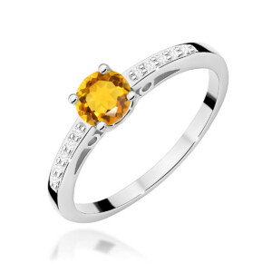 Silver ring with a round orange gemstone center, flanked by pavé-set white stones along the band
