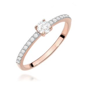 Rose gold engagement ring with a round center diamond and pavé diamonds along the band.
